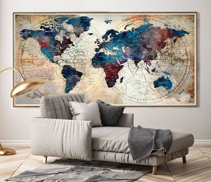 a living room with a couch, rug and large map on the wall above it