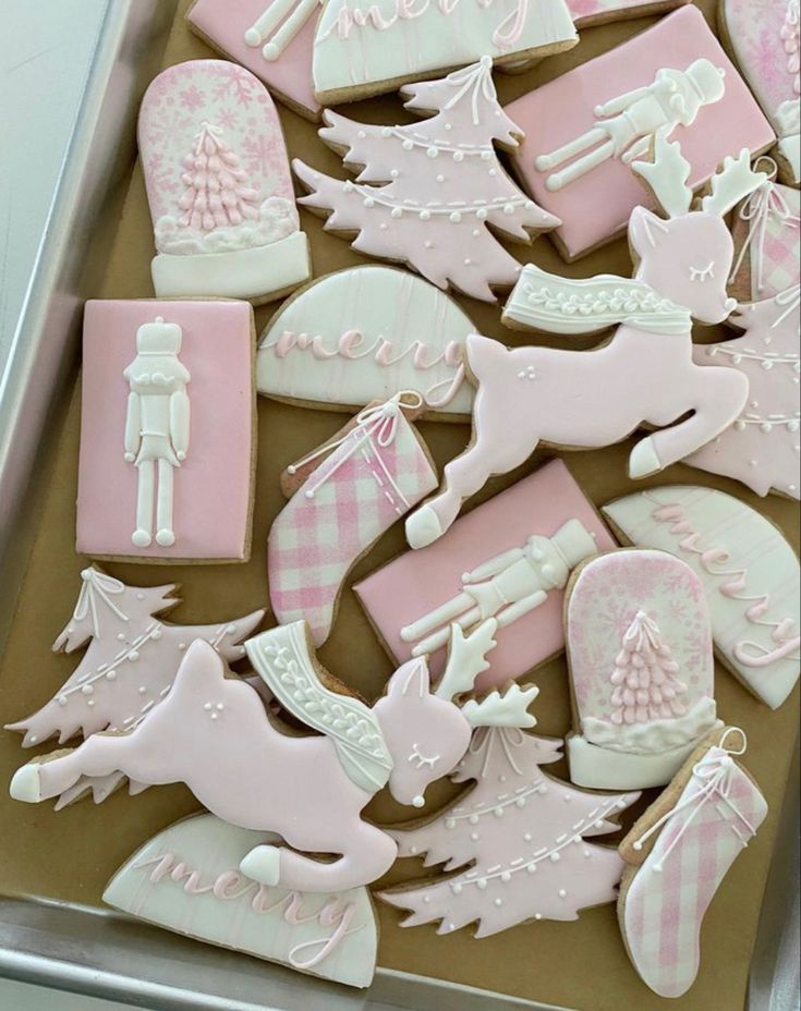 pink and white decorated cookies in a box