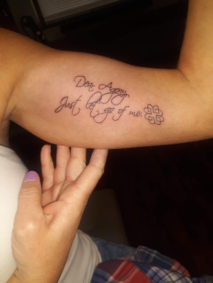 a woman with a tattoo on her arm saying don't worry, just give up