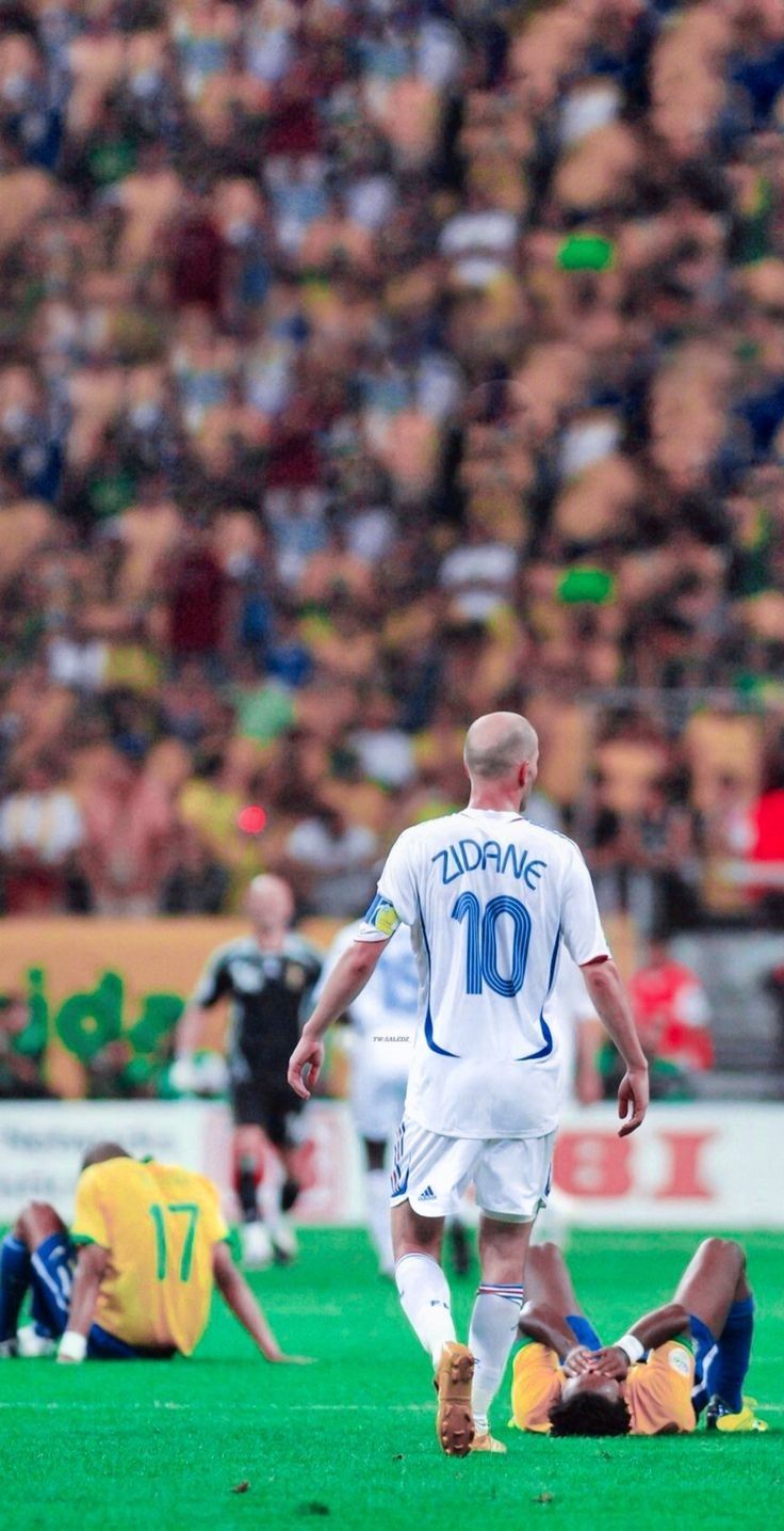 two soccer players are on the field during a game