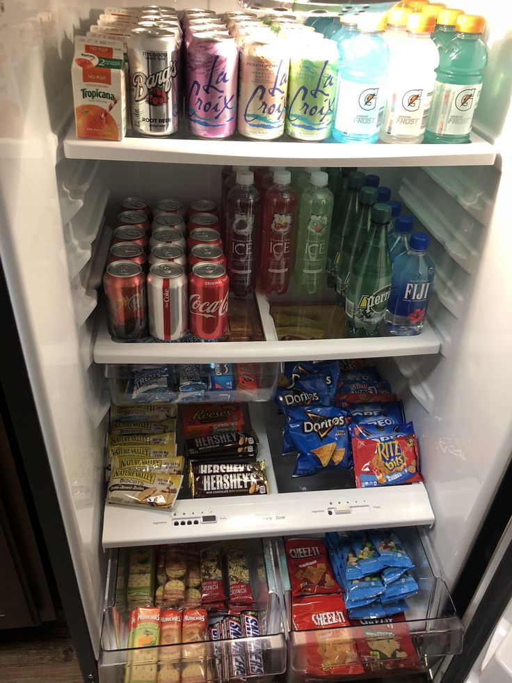 an open refrigerator filled with drinks and snacks