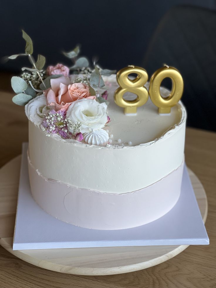 a white cake with flowers and the number 98 on it