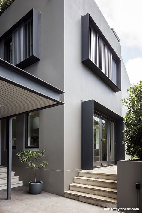 an exterior view of a modern house with stairs