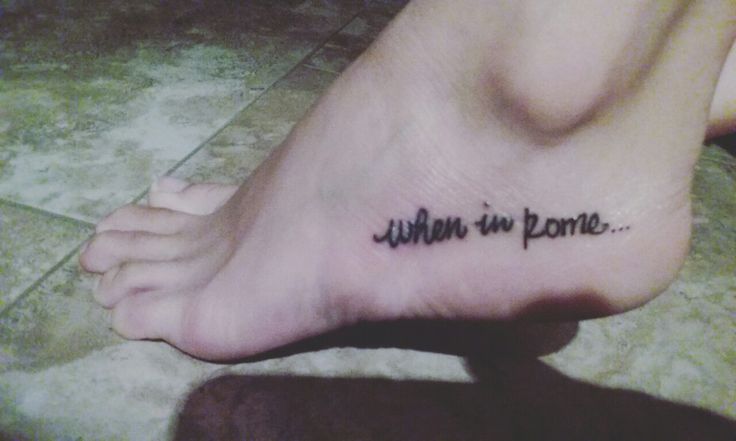 a person with a tattoo on their foot that says, john in rome written below