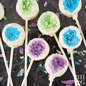 there are some cake pops with blue and green frosting on them