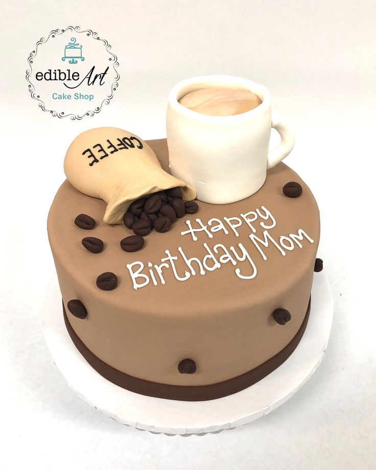 a birthday cake with coffee and doughnuts on it