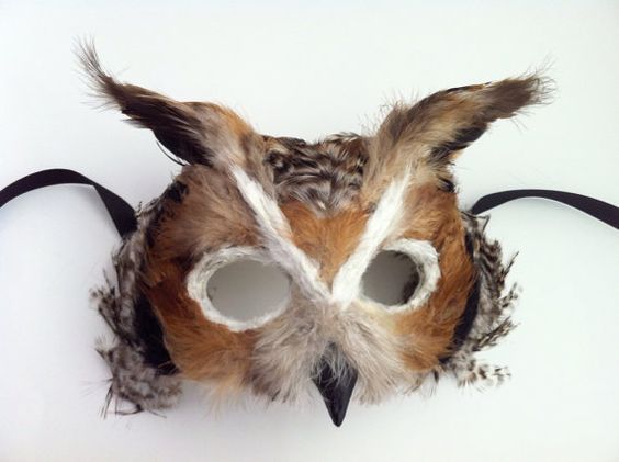 an owl mask with white and brown feathers