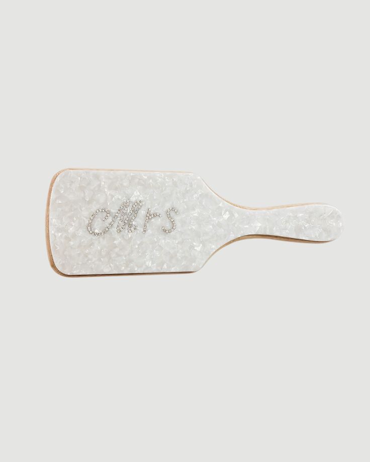 a white hair brush with the word's on it