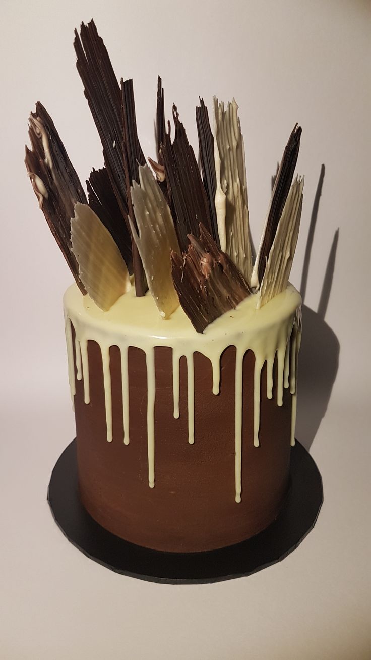 a cake with chocolate and vanilla icing drizzled on the top is shown