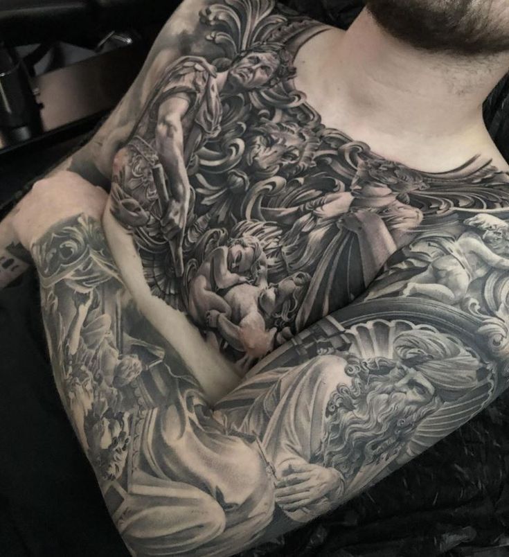 a man with tattoos on his arm and chest