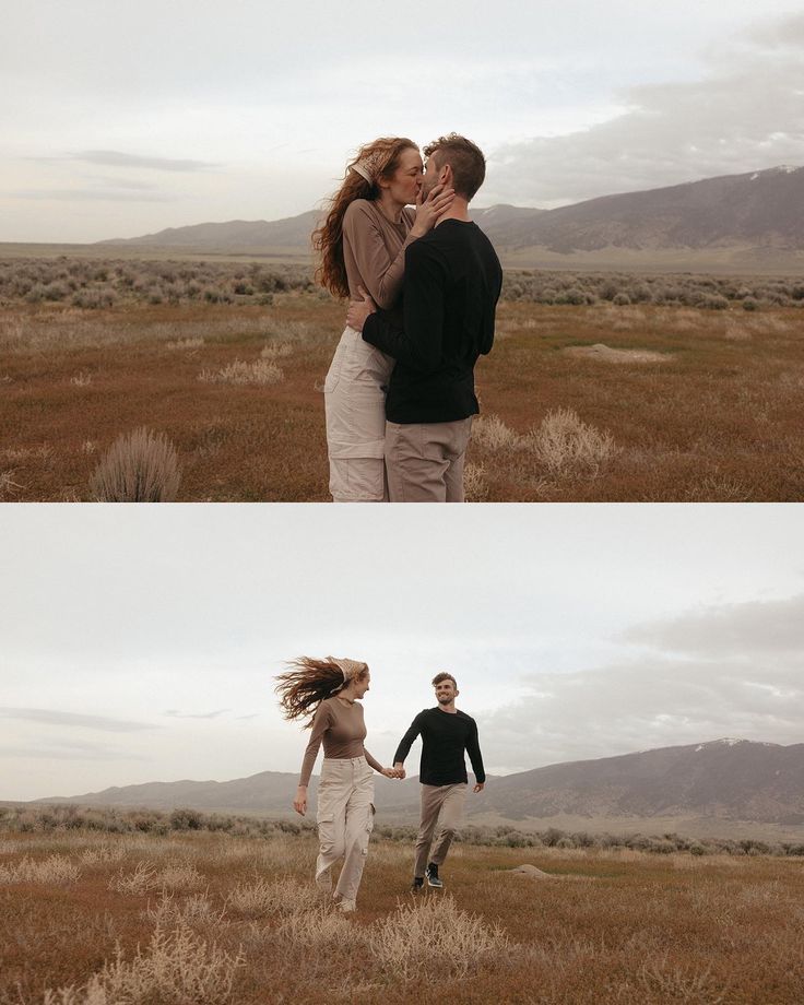 two people holding hands and walking through the grass with mountains in the background at sunset