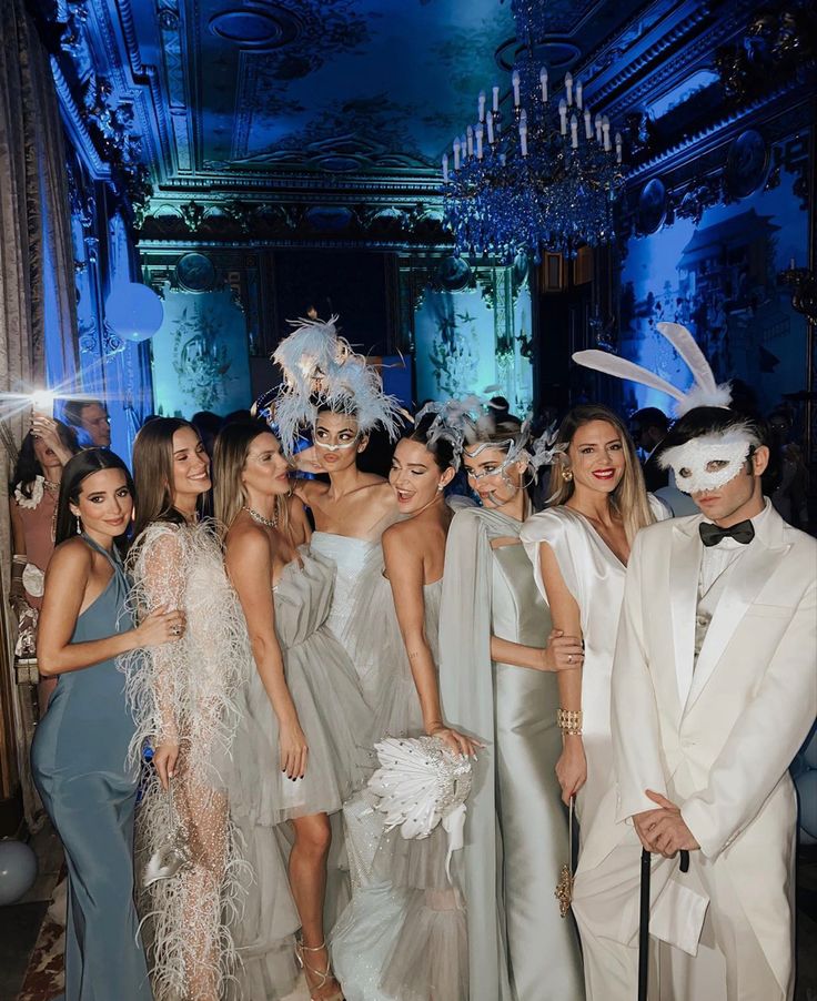 a group of women standing next to each other in front of a blue light wearing bunny ears