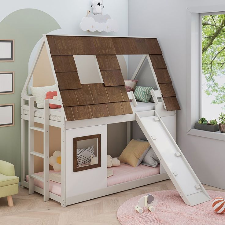 a child's bed with a slide in the middle and a house on top