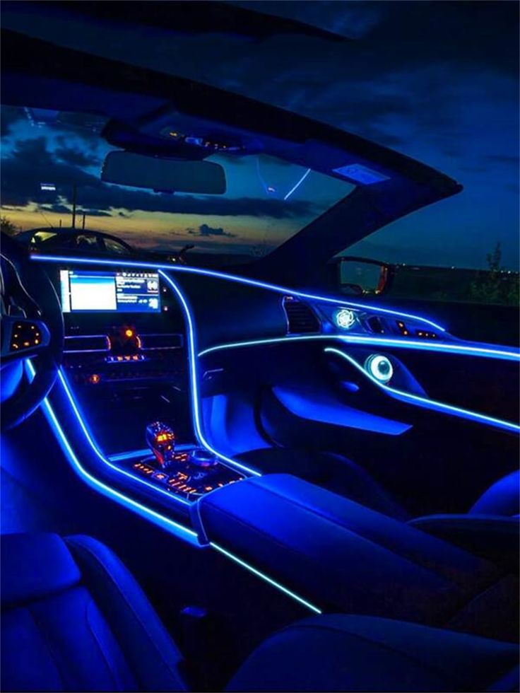 the interior of a car is lit up with blue lights