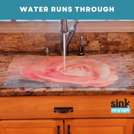 a sink that has been painted with pink flowers on it and the words water runs through