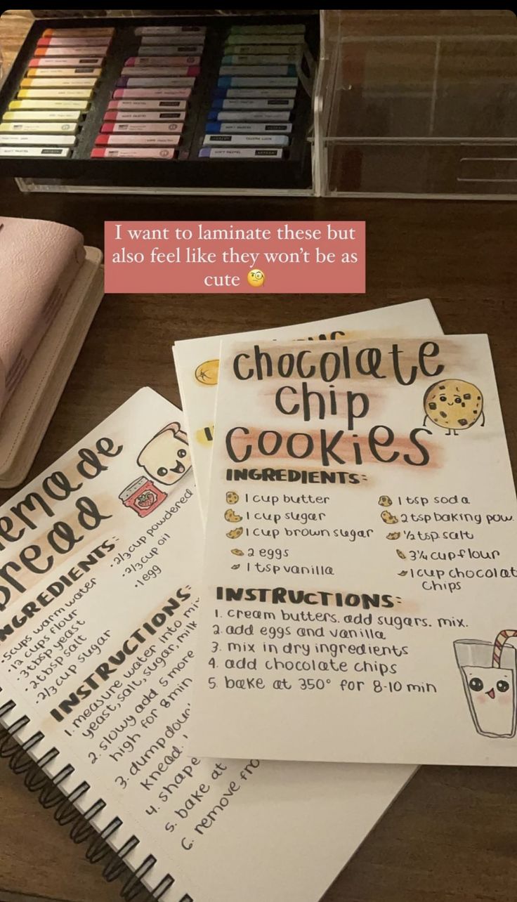 the chocolate chip cookies recipe book is next to some markers and crayon pens