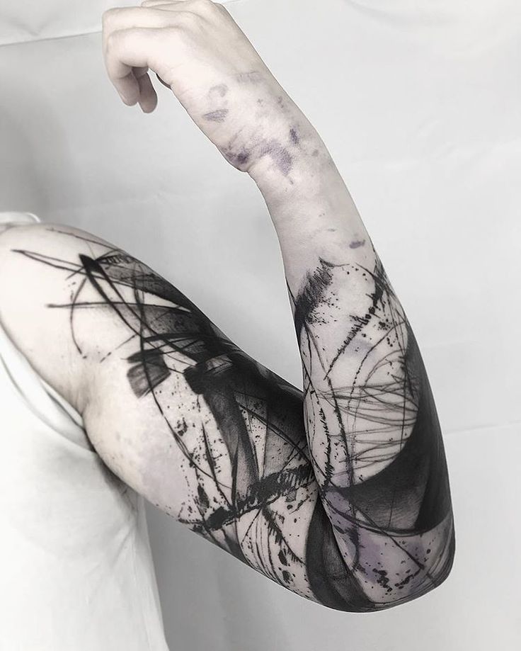 a woman's arm covered in black and white ink