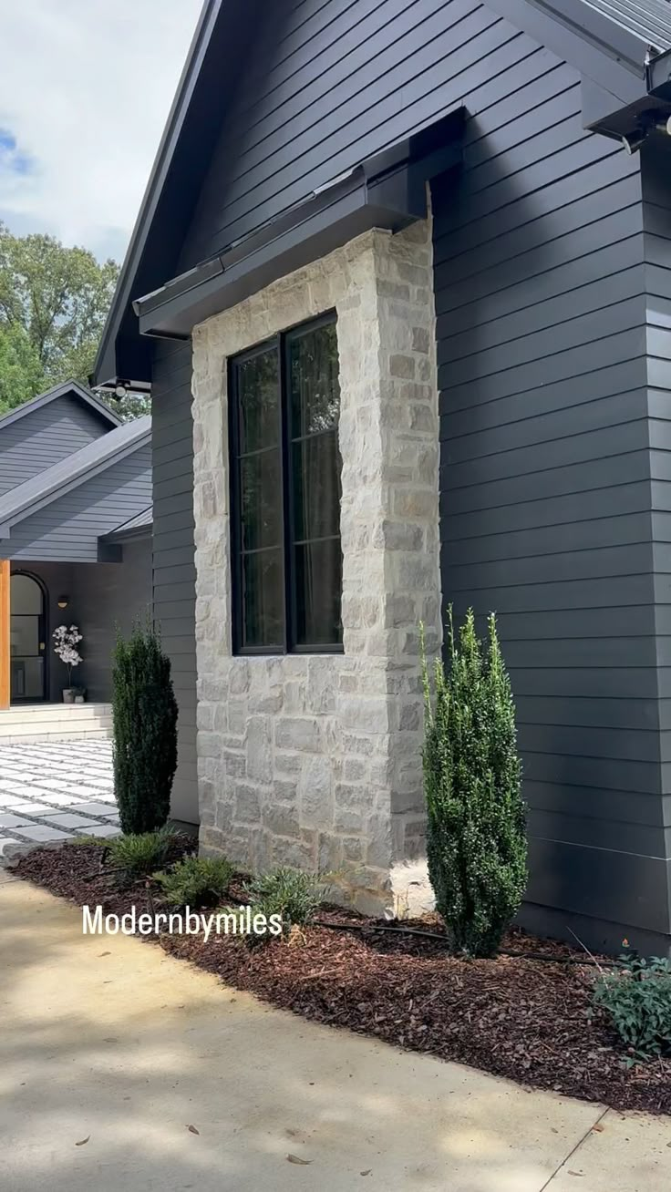 a house with grey siding and white trim