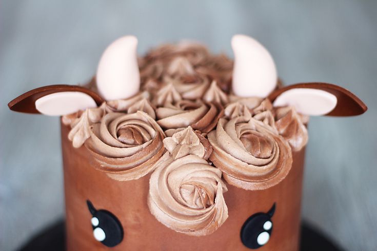 a chocolate cake decorated with flowers and horns