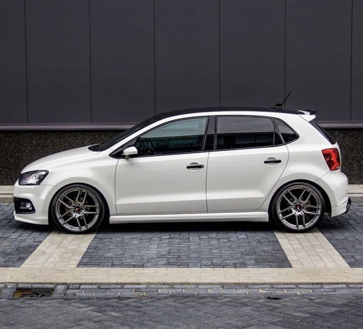 a white car is parked on the street