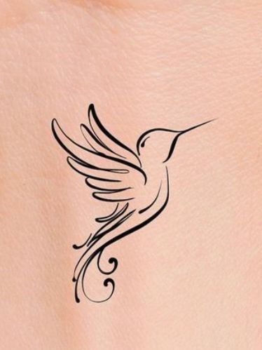 a small tattoo on the back of a woman's stomach with a humming bird