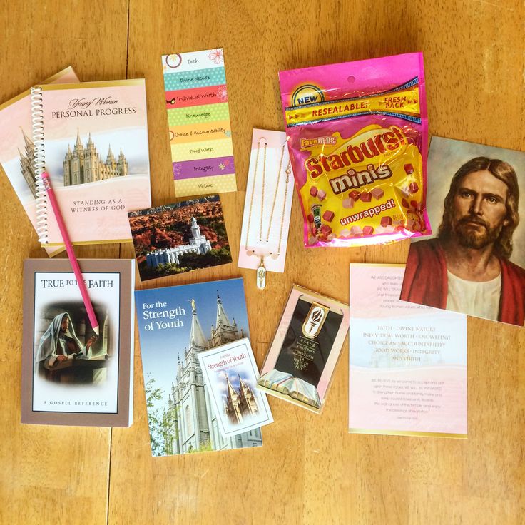 the contents of a travel kit laid out on a wooden table with pens and paper