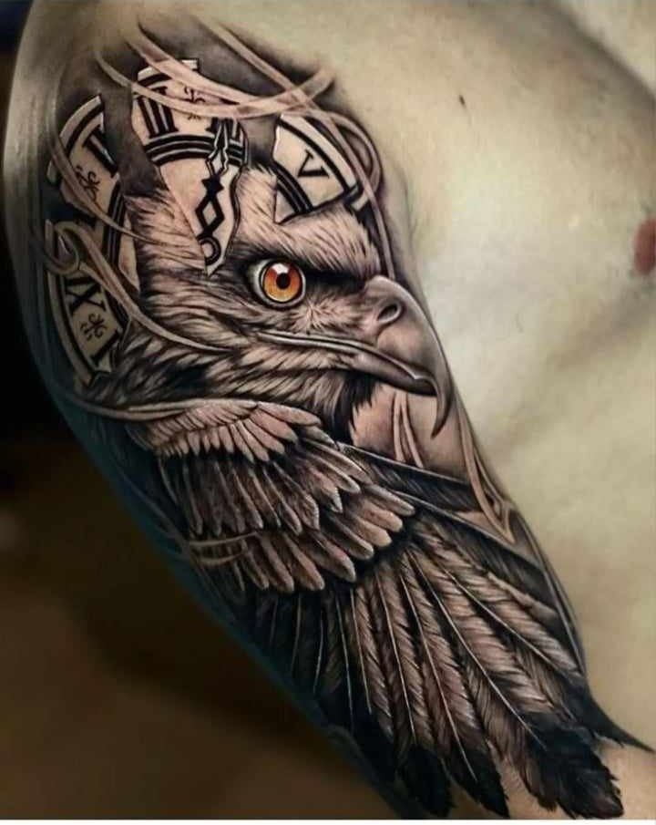 an eagle with a clock on it's head is shown in this tattoo design