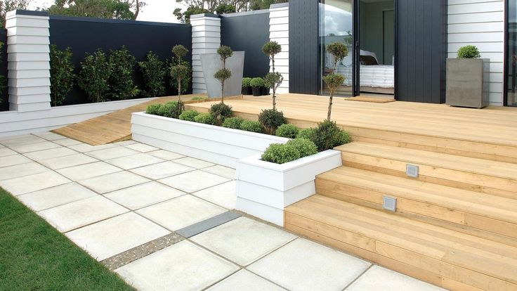 an outdoor area with wooden steps and planters