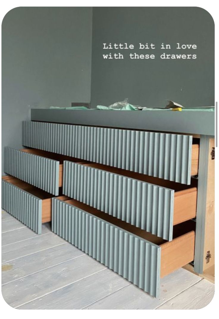 the drawers are made out of corrugated and have words written on them in white lettering