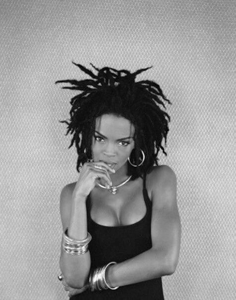 an image of a woman with dreadlocks on her head and wearing a black tank top