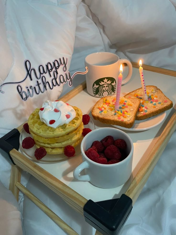 a tray with pancakes, raspberries and toast on it that says happy birthday