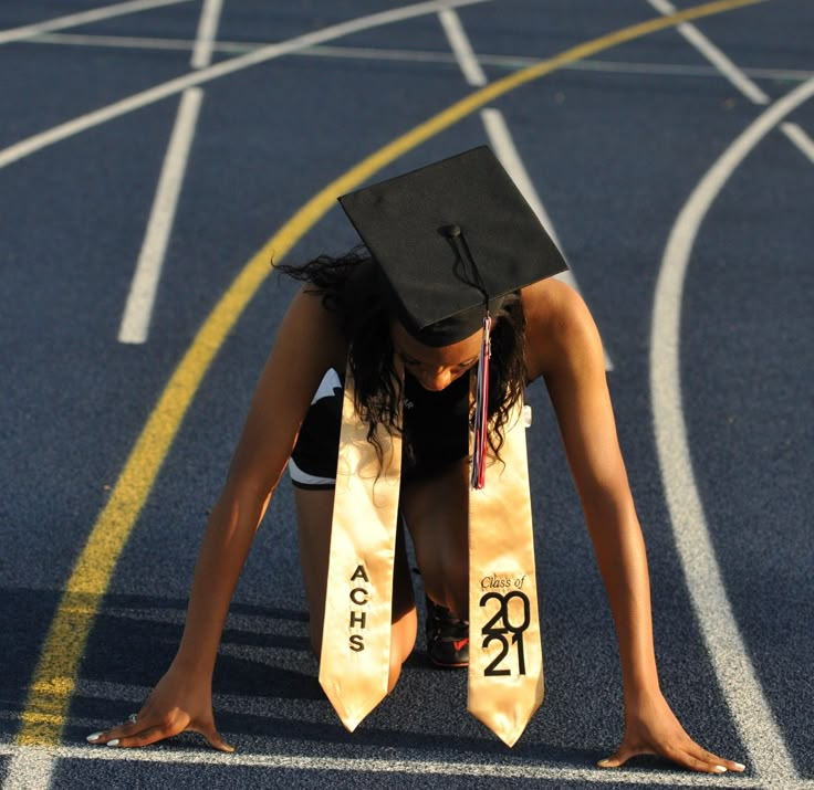 Graduation Pictures Sports, Track And Field Graduation Pictures, Senior Picture Ideas For Runners, Graduation Track Pictures, Track Graduation Pictures High Schools, Senior Picture Cross Country, Xc Senior Pictures, Long Jump Senior Pictures, Senior Picture Ideas Track And Field