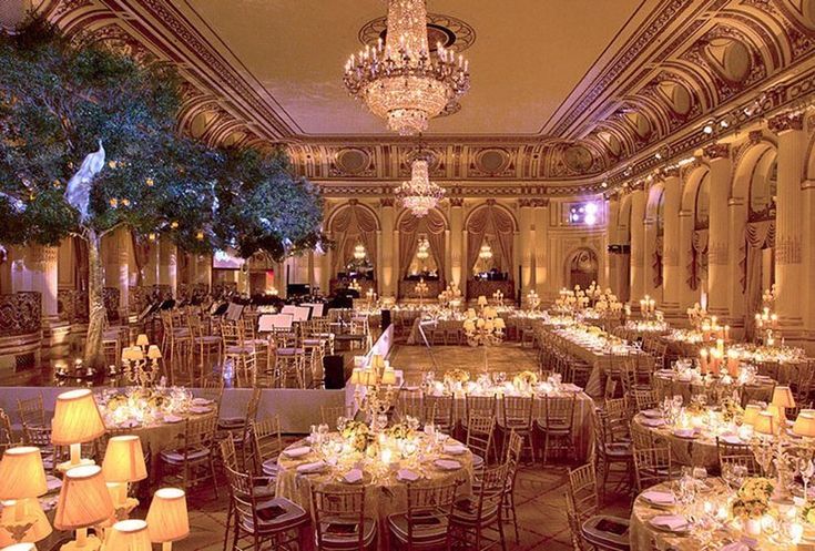 an elegant ballroom with chandeliers and tables