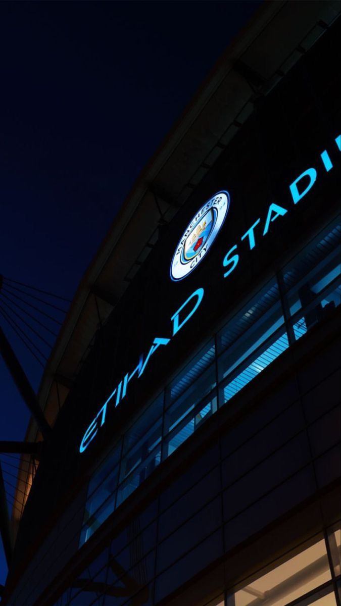 the stadium sign is lit up at night