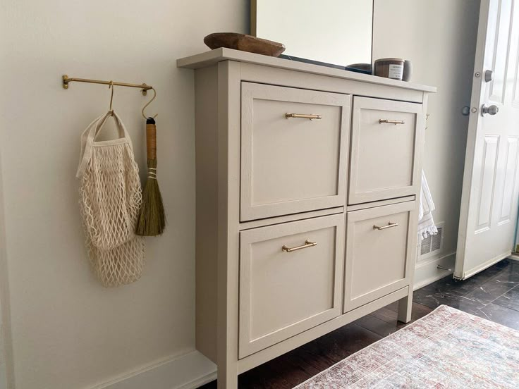 a white cabinet and mirror in a room