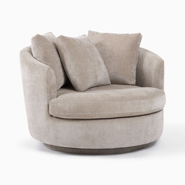 a round chair with two pillows on it's back and the seat upholstered