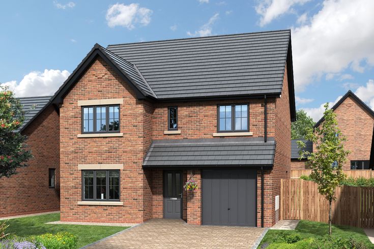 a two story brick house with grey garage doors