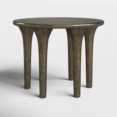 an oval table with two legs and a circular top, made out of bronze metal