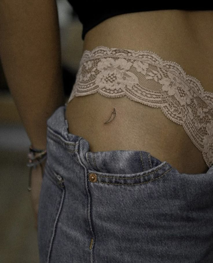 a woman's stomach with a small tattoo on her lower body and the bottom part of her belly