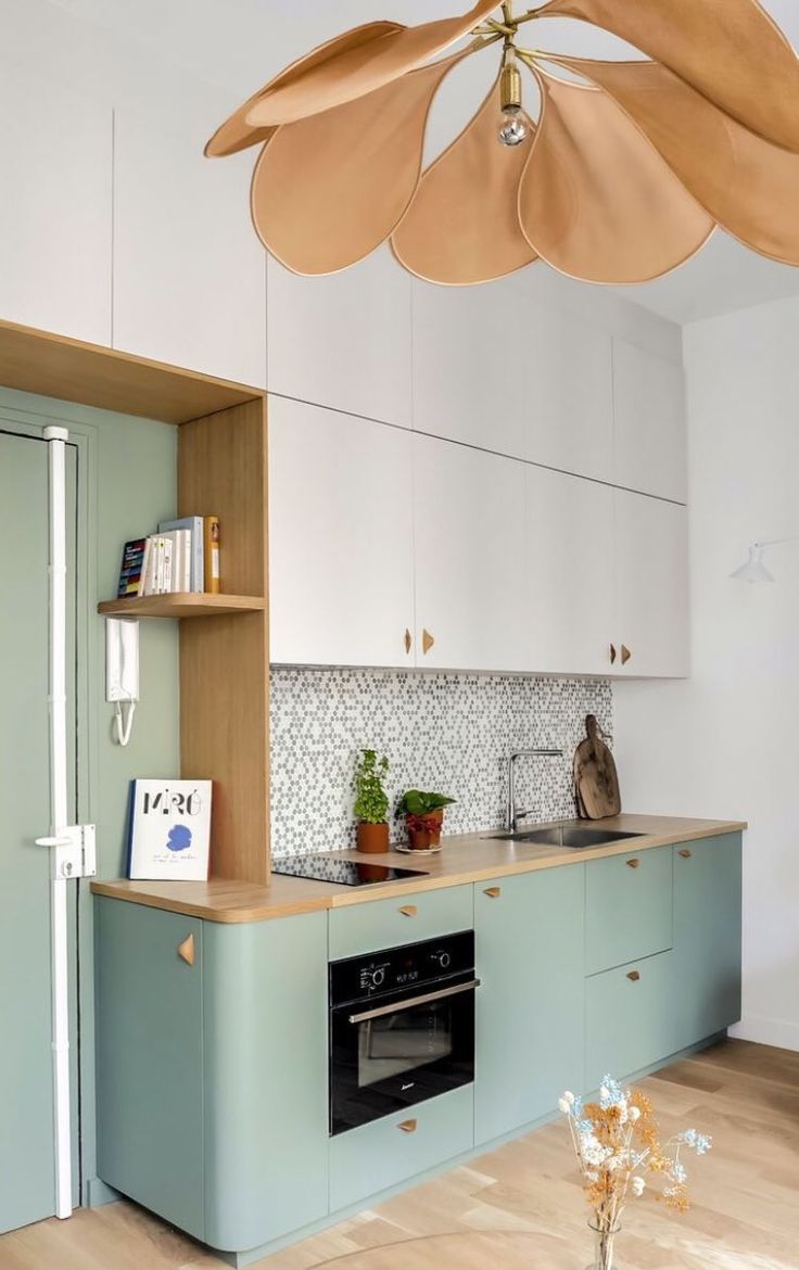 a kitchen with blue cabinets and an island in front of the stove top is shown