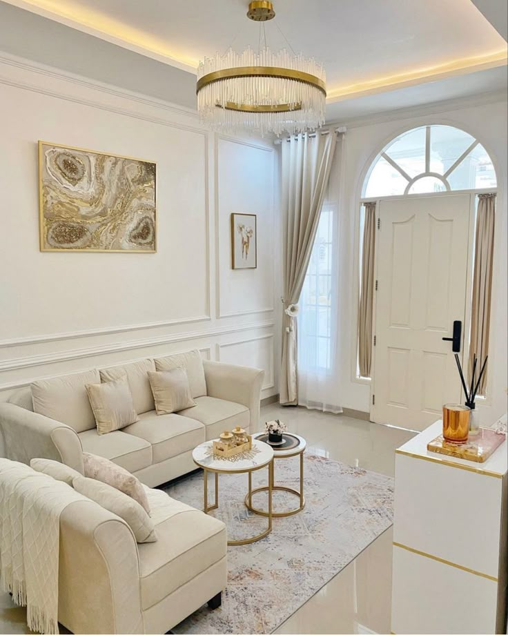 a living room filled with furniture and a chandelier