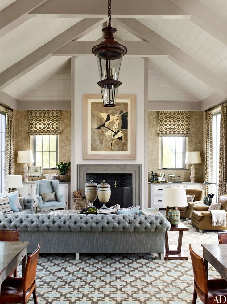 a living room filled with furniture and a fire place under a painting on the wall