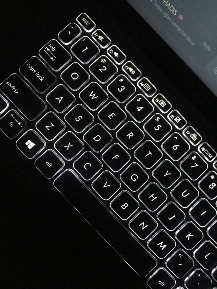 a close up view of a keyboard on a laptop computer with the keypad illuminated