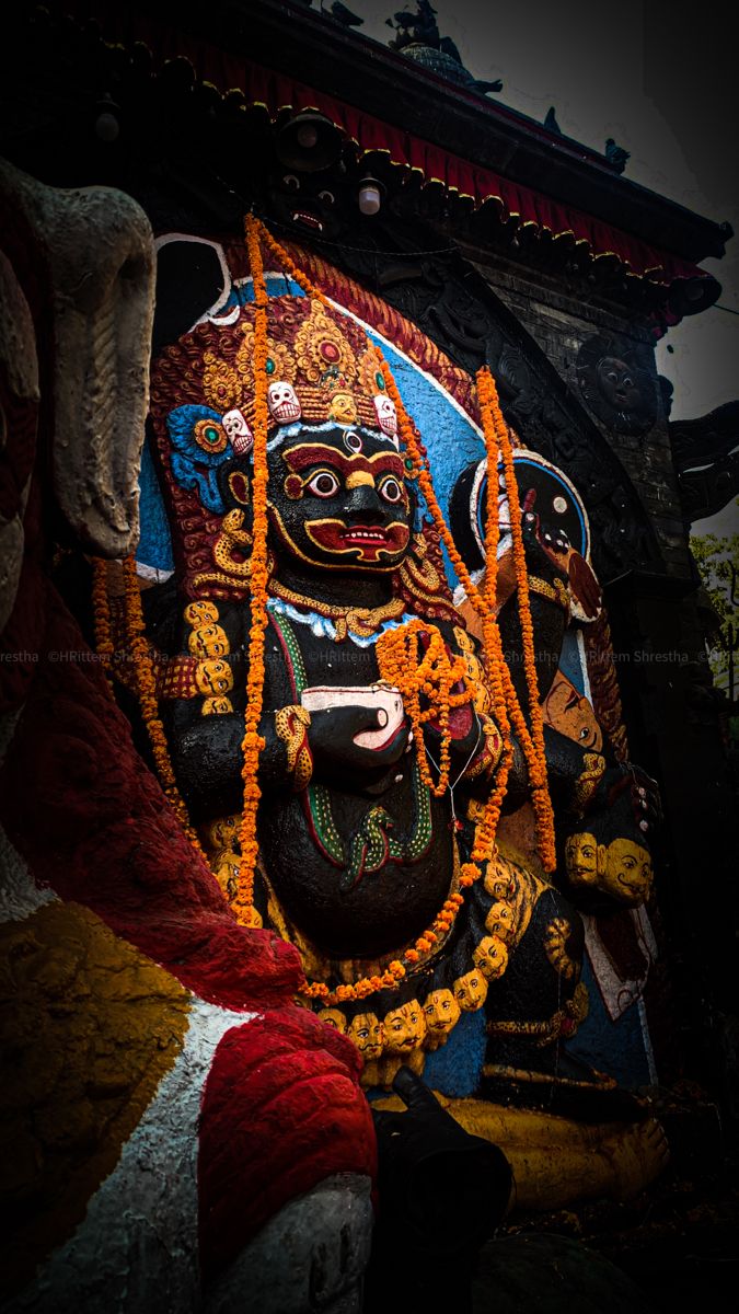 the statue is decorated with beads and chains