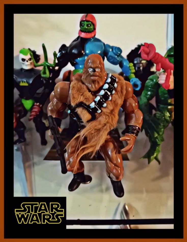 star wars action figures are displayed on a table with an orange border around them and in the background is a black frame