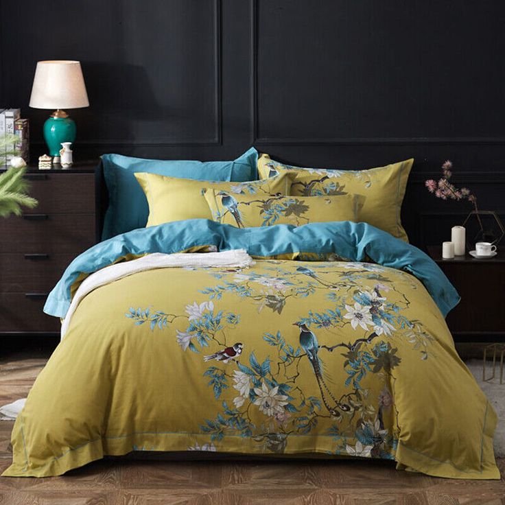 a bed covered in yellow and blue comforters