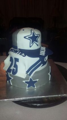 a birthday cake made to look like a football player's hat and uniform on top