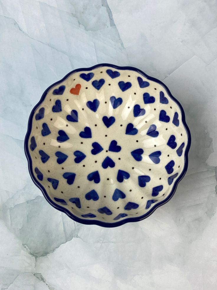 a blue and white bowl with hearts on it