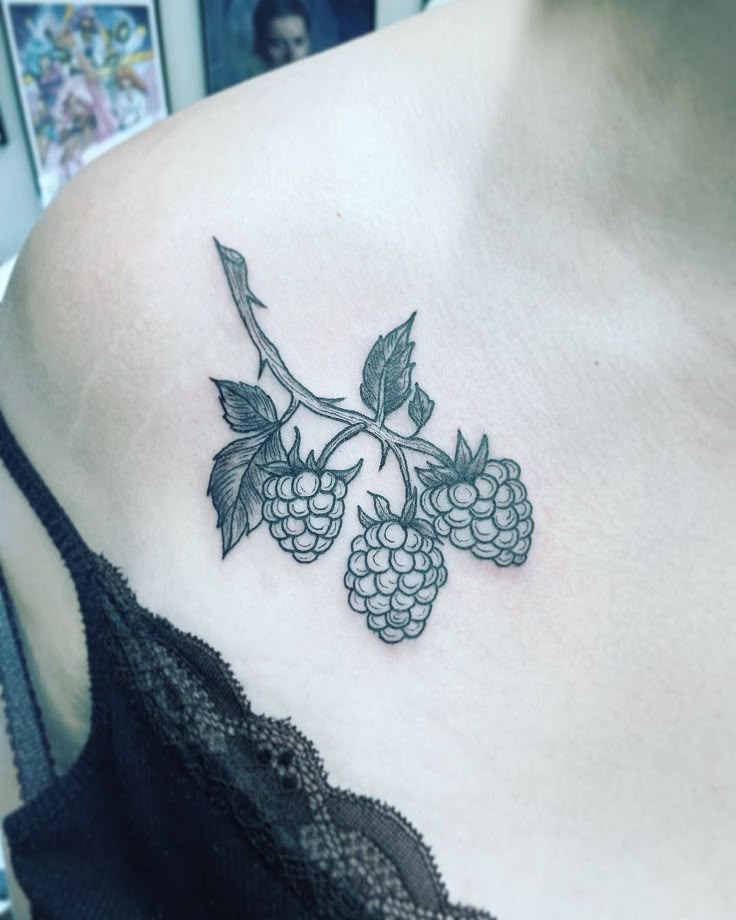 a woman with a tattoo on her chest holding a piece of fruit in her hand