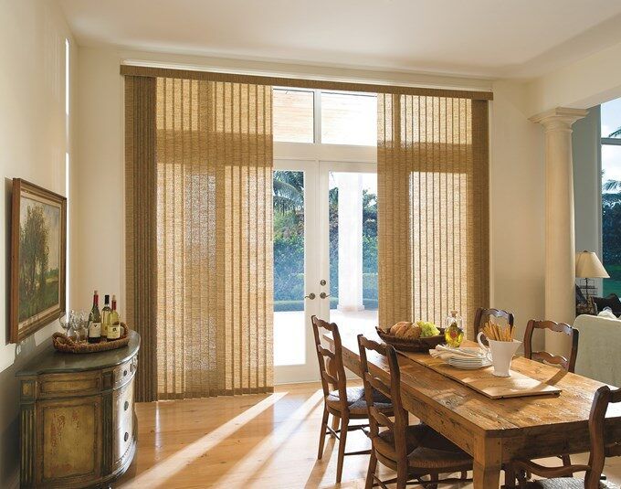 a dining room table and chairs with sliding glass doors